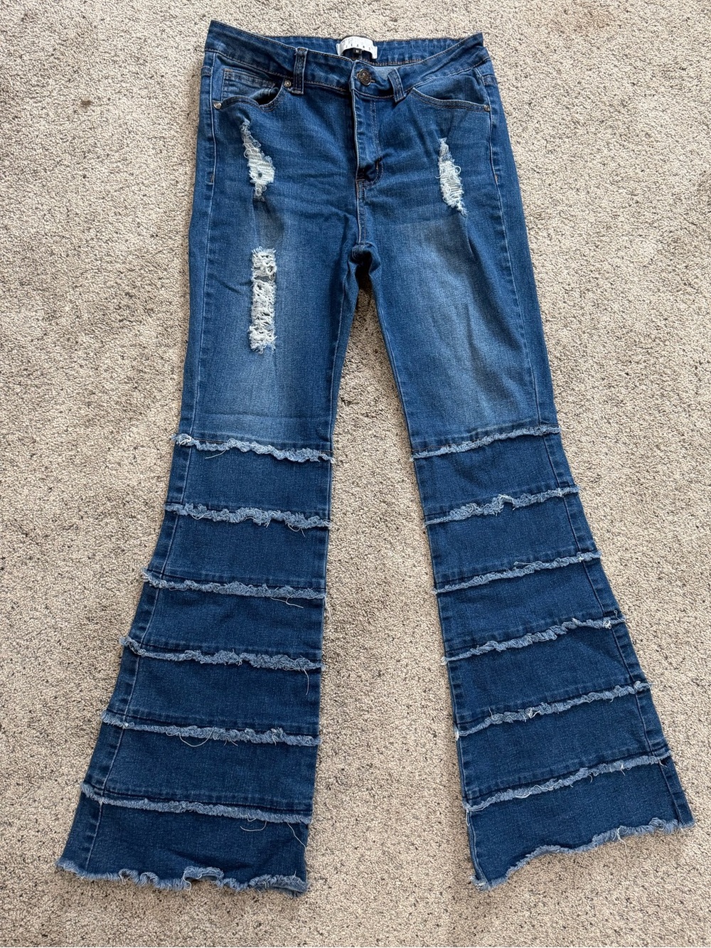 Distressed Dark Blue Flared Jeans with Tiered Ruffle Detail